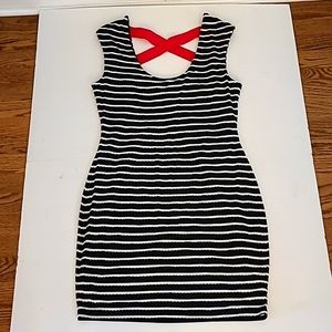 Blue and white form fitting Guess dress with red criss-cross straps on the back